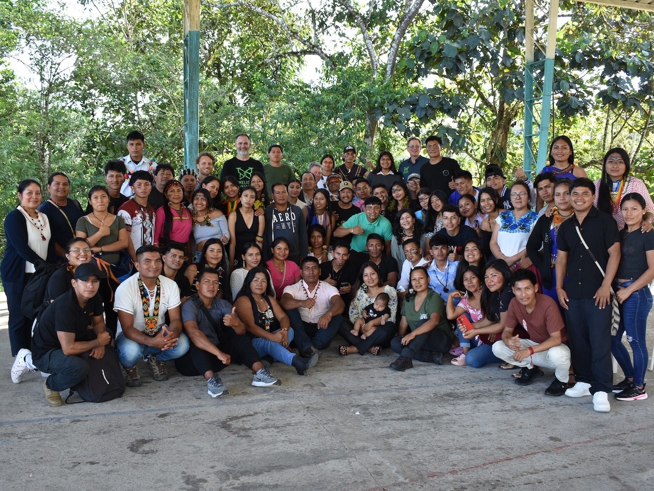big group of people smiling in rainforest