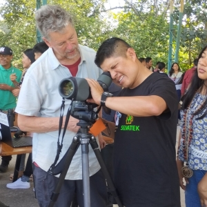 man teaching student with telescope